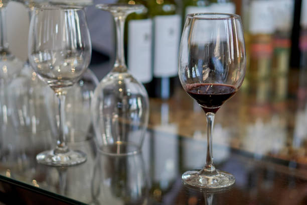 istock several glasses of wine on a glass table in a wine cellar at a wine tasting. Selective focus 2160074598
