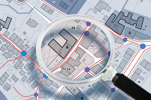 istock Layout of facilities and services systems, plant engineering located below street level - Concept with imaginary cadastral map seen through a magnifying glass 2160078016