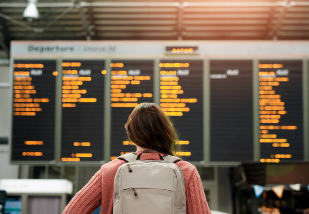 istock Woman, back and airport with flight schedule on board with information display for global immigration. Person, backpack and international travel with digital time table on screen, location or arrival 2160079298