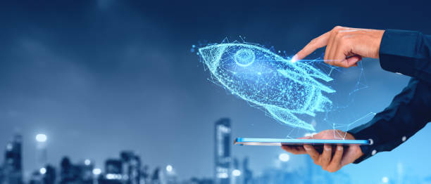 istock A person's hand interacting with a holographic rocket projected from a tablet, against a cityscape at twilight, symbolizing innovation and start-up 2160079719
