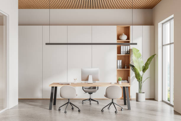 istock Stylish office interior with work desk and shelf with panoramic window 2160080325