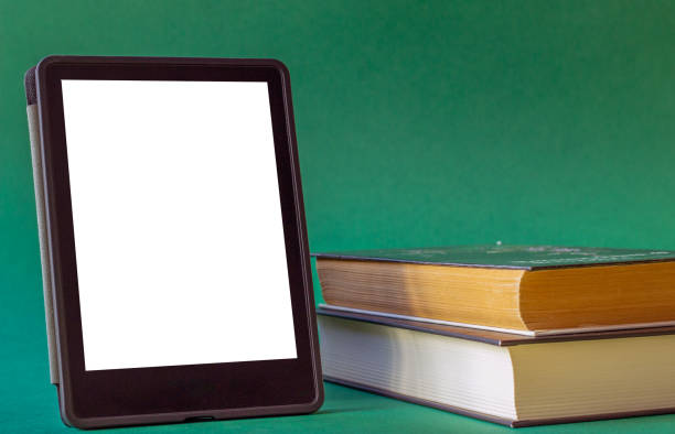istock an electronic book next to a stack of paper books on a dark green background 2160082857