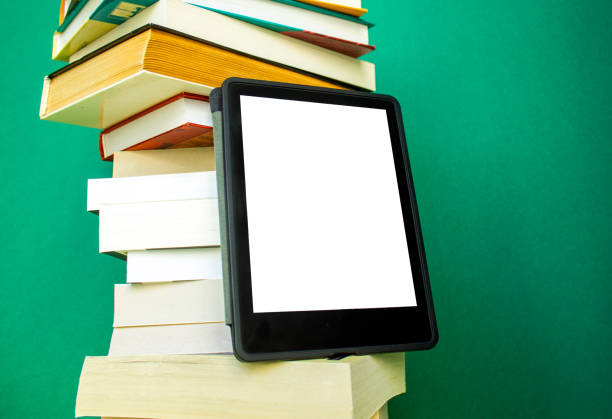 istock an electronic book next to a stack of paper books on a dark green background 2160082889