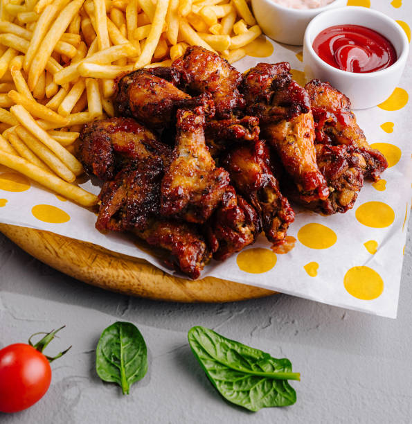 istock Crispy chicken wings and fries with dips on table 2160086179