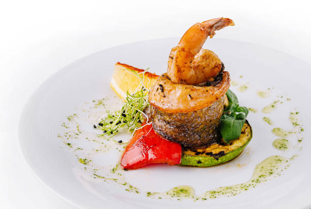 Elegant shrimp dish paired with grilled vegetables and garnish on a white plate
