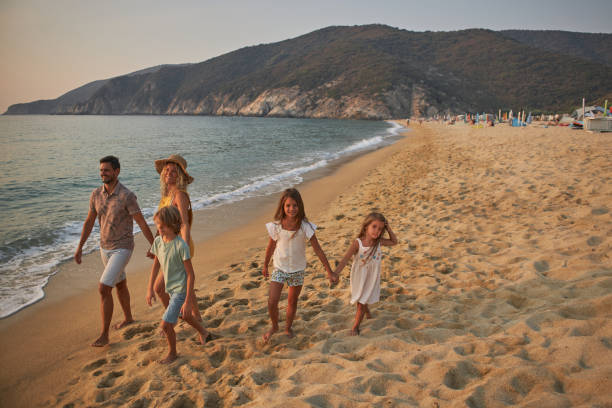 istock A family walks hand in hand down a tropical paradise beach during sunset 2160086465