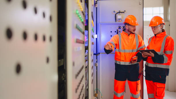 istock Two Electrical engineer working in control room at industry factory. 2160086791