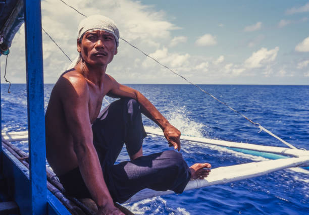 Boracay, Philippines - June 24, 2024: Sailor sailing in a traditional boat