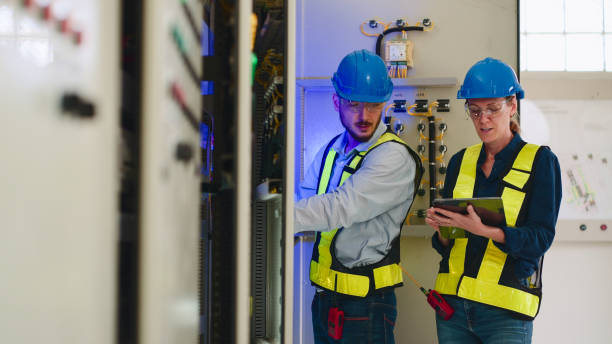istock Two Electrical engineer working in control room at industry factory. 2160086814