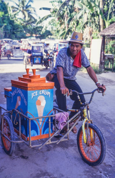 Boracay, Philippines - June 24, 2024: Ice cream seller riding a tricycle