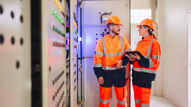 istock Professional industrial engineers operating in electricity substation. 2160088053