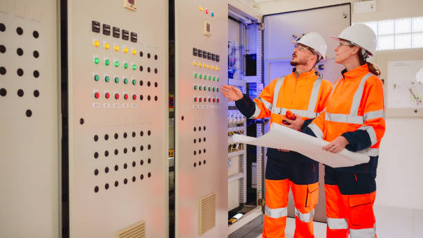 istock Professional industrial engineers operating in electricity substation. 2160088072