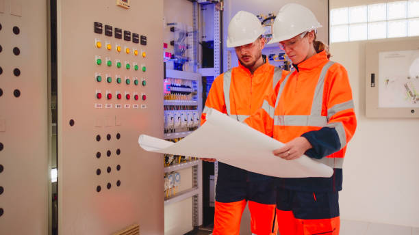 istock Professional industrial engineers operating in electricity substation. 2160088076