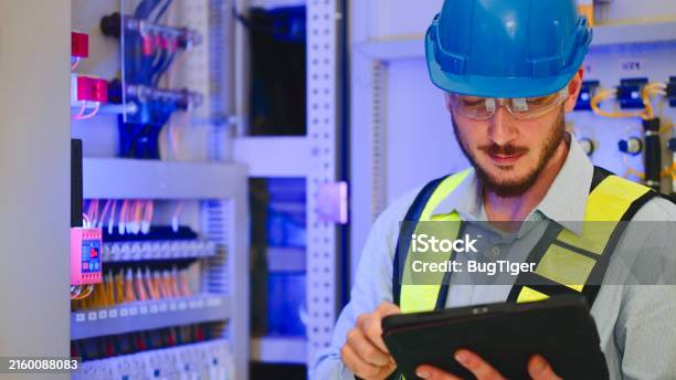 Checing Power Electrical Engineer Checking Power At Control Room Using Digital Tablet ...