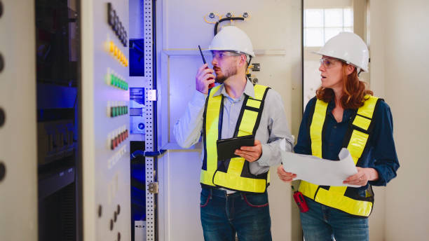 istock Electrical engineer checking power at control room using digital tablet and walkie-talkie. 2160088798