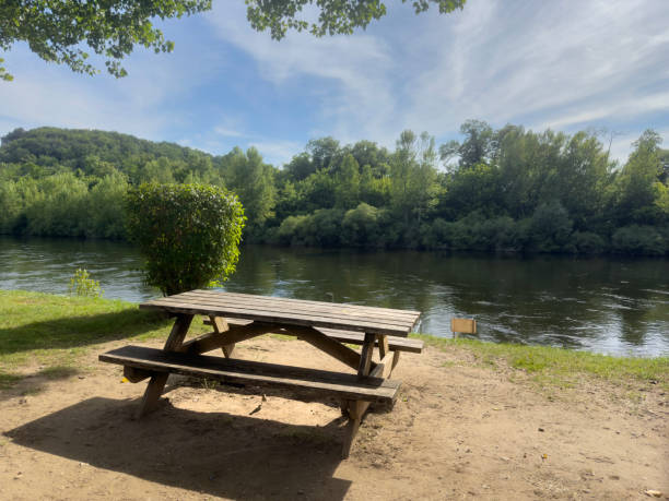 istock empty wooden picnic table in the park by river 2160093677
