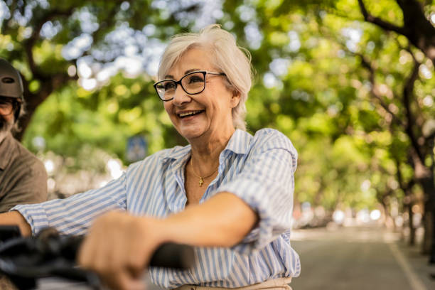istock Senior Woman Riding Bicycle in Park 2160096357