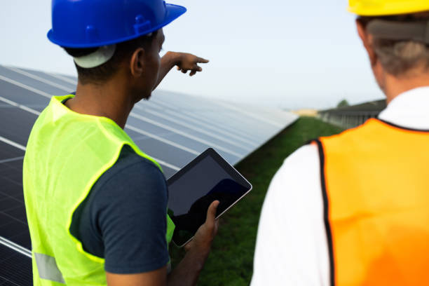 istock Two workers planning the improvement of the solar energy system 2160096388