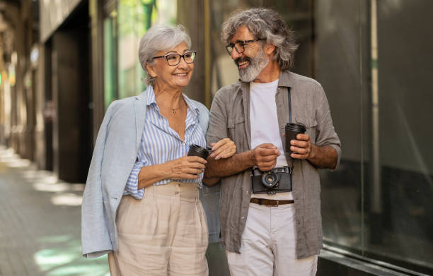 Senior Couple Walking and Enjoying Coffee Together