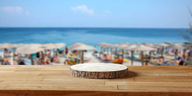 istock Wooden table with copy space for products with blurred  beach and sea background. 2160096863