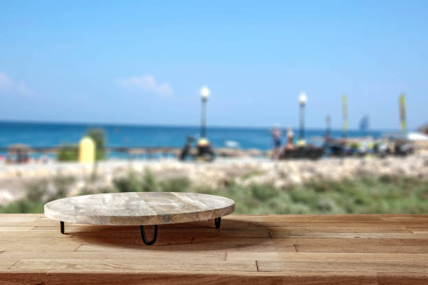 istock Wooden table with copy space for products with blurred  beach and sea background. 2160096880