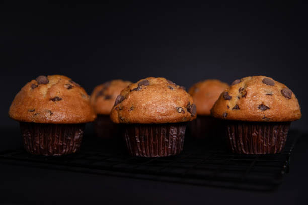 istock Chocolate muffins with chocolate chips on a black background. 2160098153