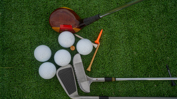istock Golf ball and wooden driver on green grass background. 2160099656