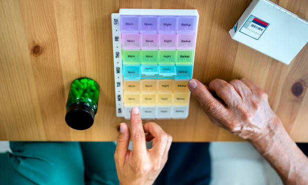 istock Home nurse helps senior patient organize medication 2160104562