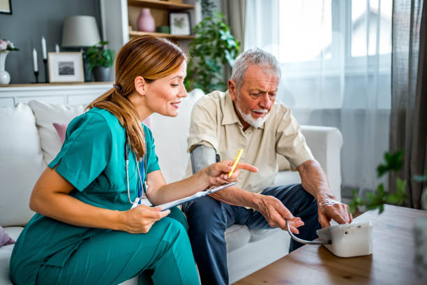 istock Home nurse checking senior man's blood pressure 2160104684