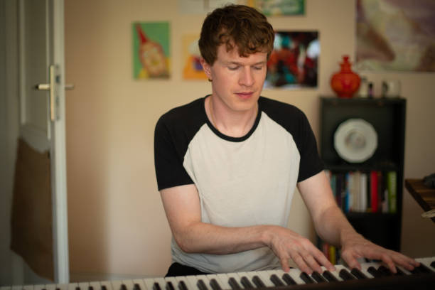istock Young, cool musician playing the keyboard 2160107057