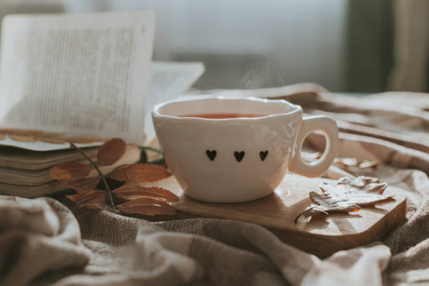 istock Autumn composition with a cup of tea, leaves and book 2160109531
