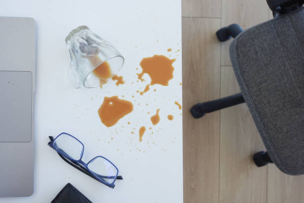 istock A drink was accidentally spilled on a desk with a laptop and glasses, creating a mess 2160110059