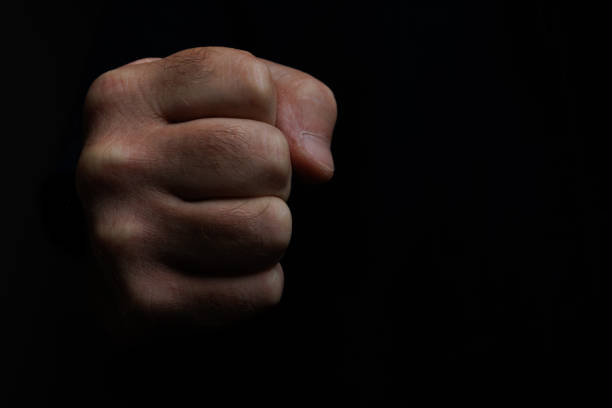 Human fist with black background and negative space, Alcoy, Spain