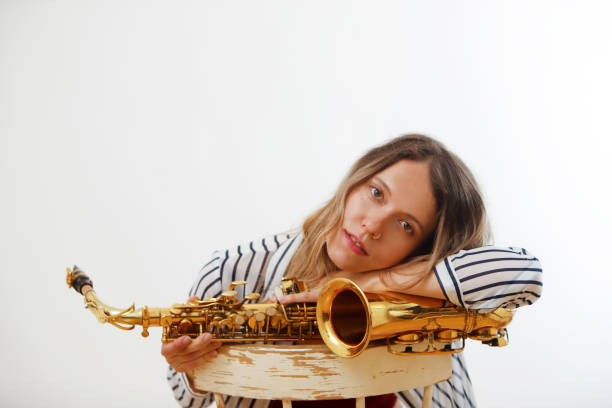 istock female saxophonist resting on saxophone looking into camera 2160112002