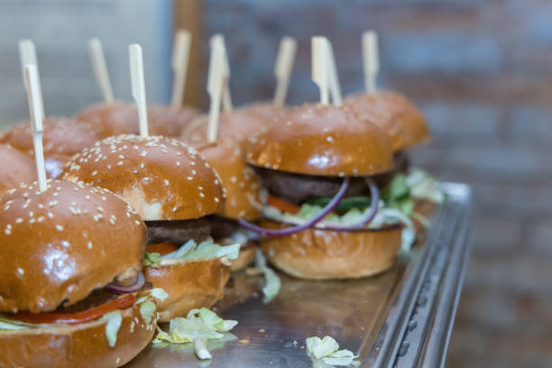 istock Meat hamburgers with vegetables are on the snack table. 2160113588