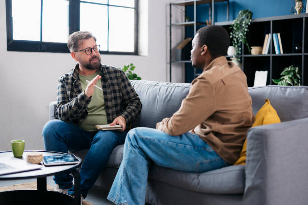 istock Psychologist supporting male patient during therapy session 2160120288