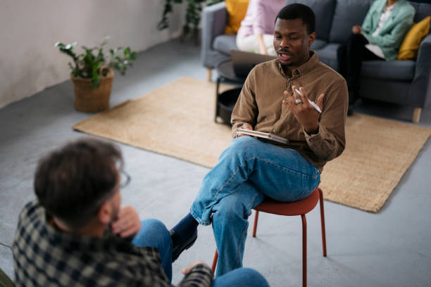 istock Psychologist providing support and advice to a male patient during a therapy session 2160120942