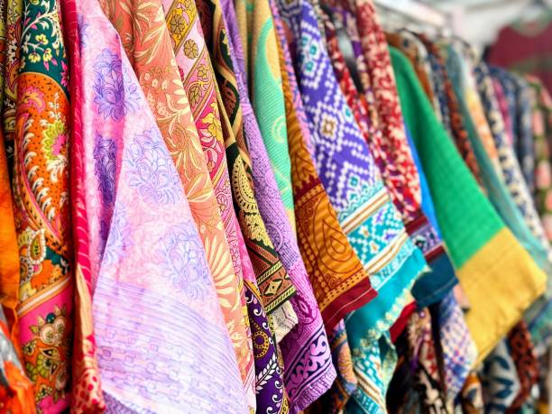 istock Colourful clothing hanging from a rack 2160125335