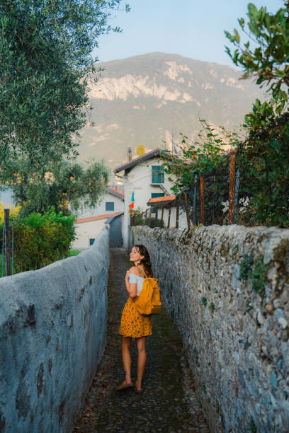 Woman on vacation at lake Como exploring old town in summer