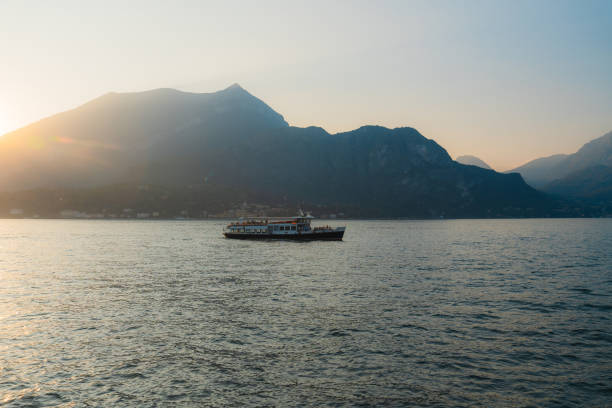 Scenic view of boat  on lake Como in summer at sunset