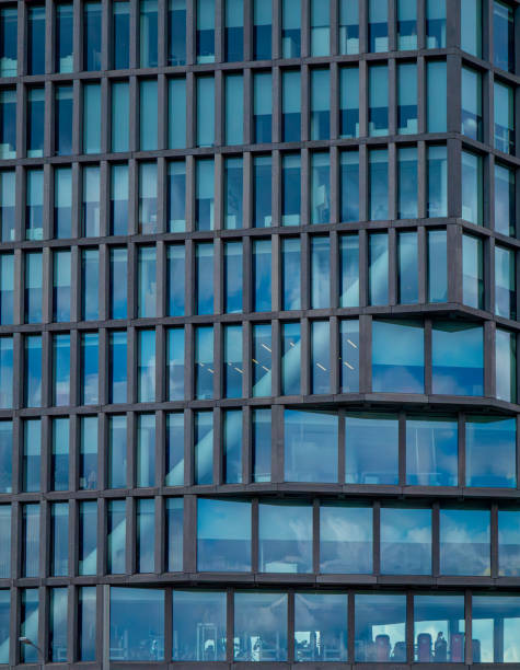 istock windows in a skyscraper in the city. Huge modern building with huge windows. interesting modern architecture and urban construction 2160129563