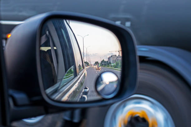 istock side car right mirror while driving in the evening 2160129734