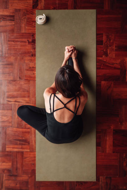 istock Woman stretches her leg with a yoga pose. 2160130204