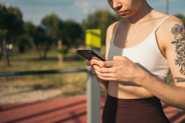 istock Fitness enthusiast checking smartphone outdoors 2160130219