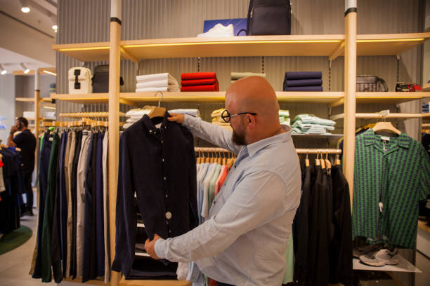 istock Man Looking For Shirts In Store 2160132065
