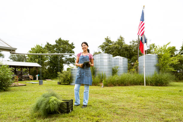 istock Farmer portrait in front of rain water collection system 2160133567