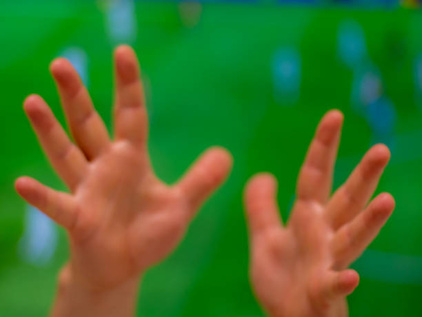 Two open hands with a green out of focus background