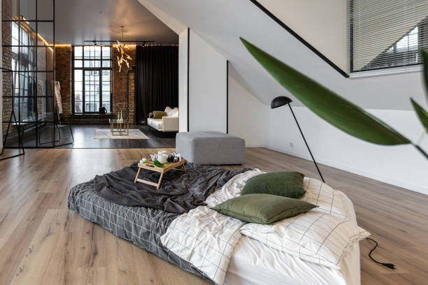 istock minimalist stylish interior of white simple bedroom with window in ceiling and sun rays without people 2160136664