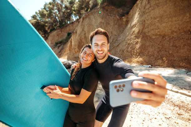 istock Young beautiful couple taking selfie on the beach 2160139929