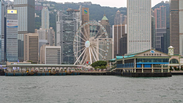 Hong Kong, China- April 23, 2017: Ferris Wheel Tourist Attraction and Maritime Museum Pier Landmark Building at Victoria Harbour.
